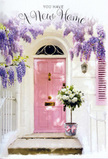 This doorway scene could easily belong to a quiet cul-de-sac near Queen's Park, where every front step tells a personal story. Here, the narrative is one of beginnings and gentle joy, written in pastel colours and fragrant petals. A softly painted pink front door serves as the centrepiece, its warm, rosy hue standing out against crisp whitewashed walls and a matching shutter that leans open just enough to hint at sunshine inside. Overhead, lavender wisteria tumbles from a sturdy vine, its blooms loose and abundant, forming gauzy curtains of purple that frame the entrance like nature's own decoration. The hanging clusters create dappled shadows on the door and the stone step below, suggesting a calm afternoon with light moving slowly across the façade. Nestled right at the threshold sits a vintage-style metal bucket in muted grey, brimming with white and cream roses that look soft enough to sink your fingers into. Each rose is layered and full, accented by sprigs of gentle green foliage, so the bouquet feels both polished and slightly wild, as if hand-gathered and then thoughtfully refined. A pale pink ribbon, tied with an easy, confident bow, encircles the bucket and quietly ties together all the hues in the scene. It feels like a housewarming gift just delivered, maybe after a stroll through the local streets around Harrow Road, a florist's way of saying, You're home now. The atmosphere that lingers is comforting, romantic, and hopeful, ideal for celebrating a move, a fresh lease, or any new chapter being started behind that inviting pink door.